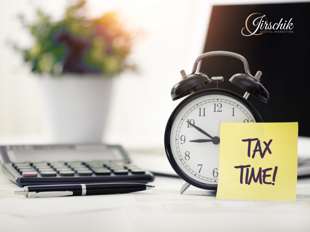 Wecker neben einem Taschenrechner mit dem gelben Notizzettel "Tax Time" als Zeichen, dass es Zeit für die Regelbesteuerung ist