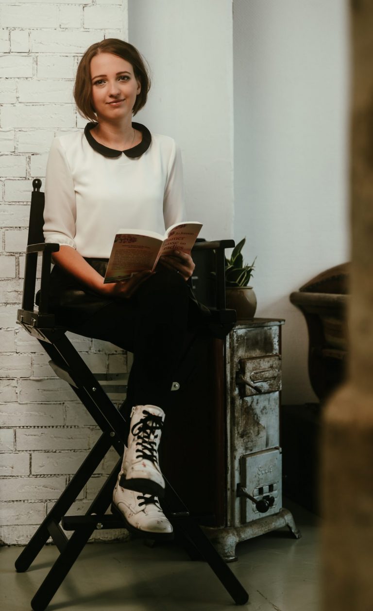 Expertin für SEO Jessica Jirschik mit einem Buch im Regiestuhl